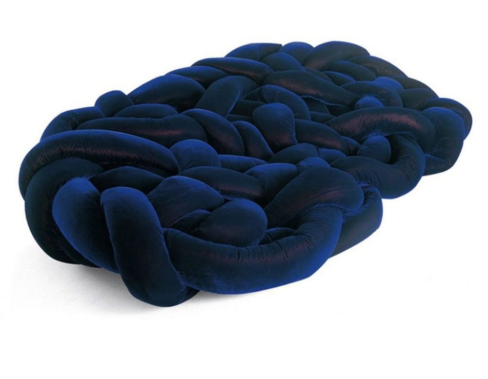 The Boa Sofa by Edra is a bold, sculptural piece made of soft velvet-wrapped tubular forms woven into a cozy, nest-like structure. Its playful, serpentine design invites relaxation from every angle.