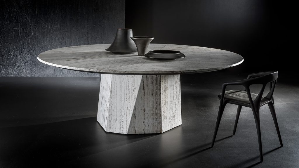 round dining table made in-house in steel covered in gray stone and wooden tops in a gray background