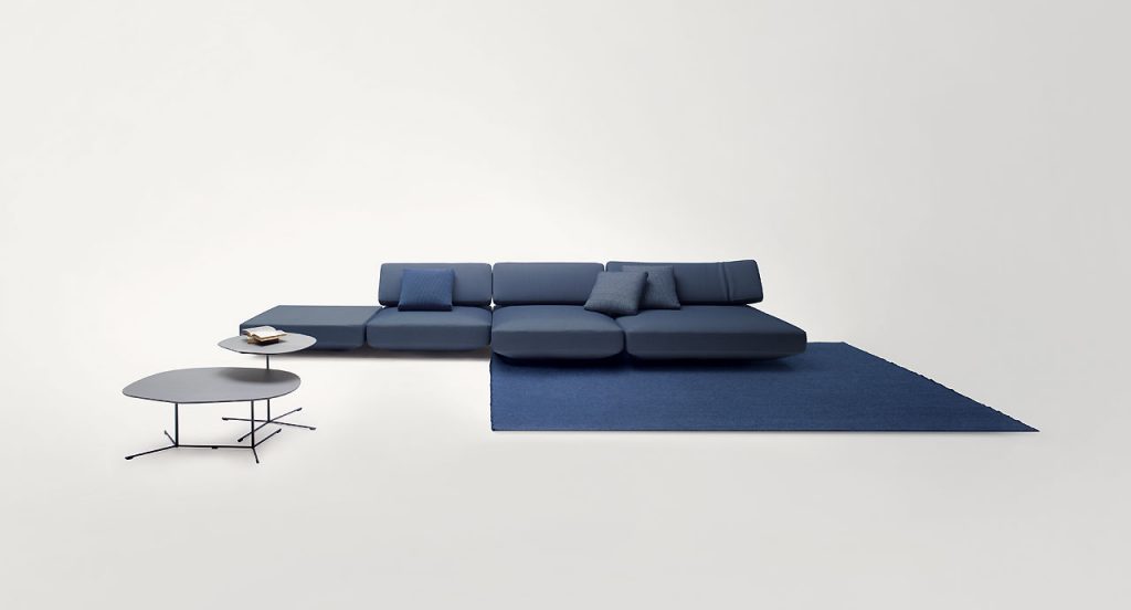 Agio Modular sofa composed of large platforms, backrest can be adjusted, all upholstered in blue fabric in a living room.